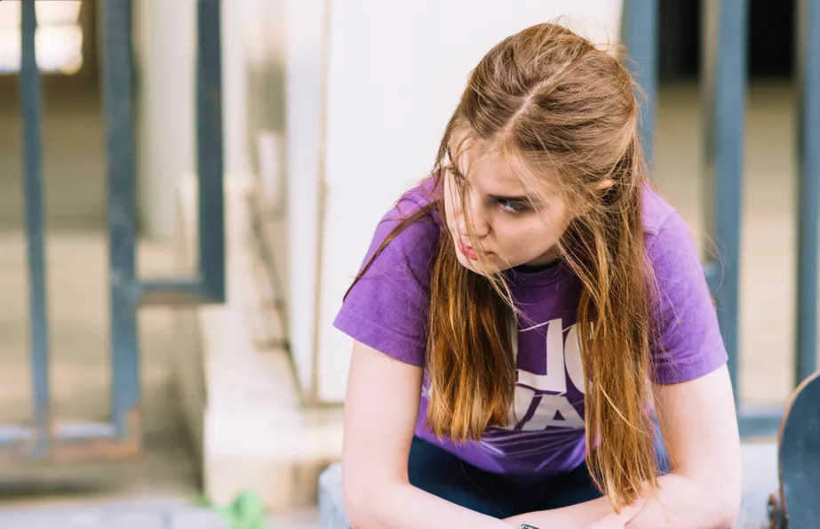 Teenage girl with hyperactive ADHD struggling with restlessness and emotional regulation