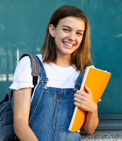Happy teen with ADHD ready for school success after learning organization and time management skills through coaching
