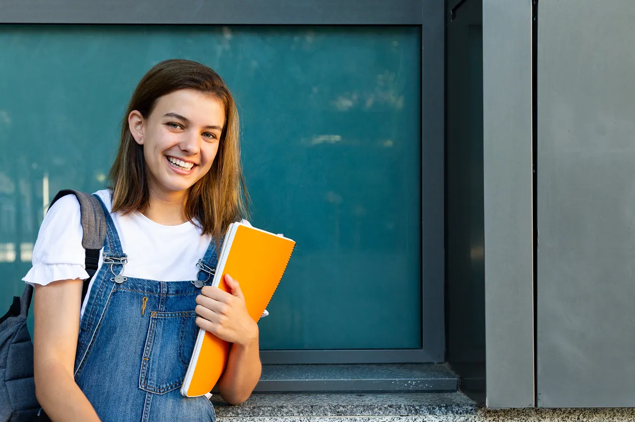 Happy teen with ADHD ready for school success after learning organization and time management skills through coaching
