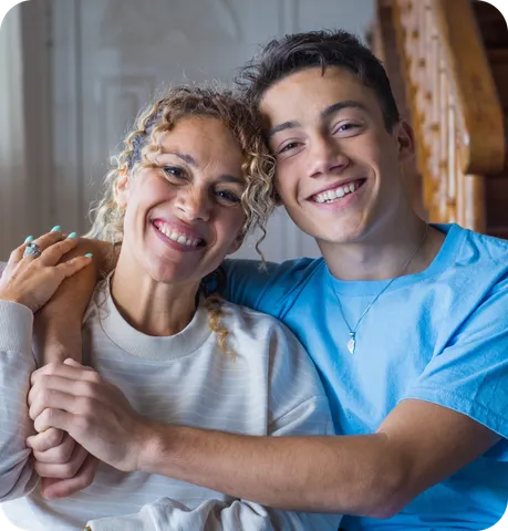 Mom and son smiling looking at the camera.